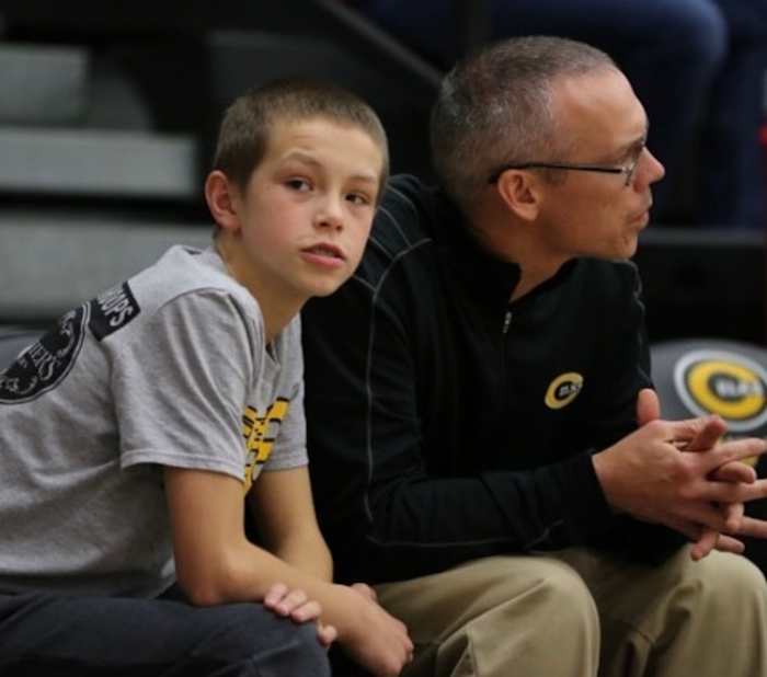 A younger Gabe Cupps (left) takes in a game with his father, Centerville head coach Brook Cupps (right).